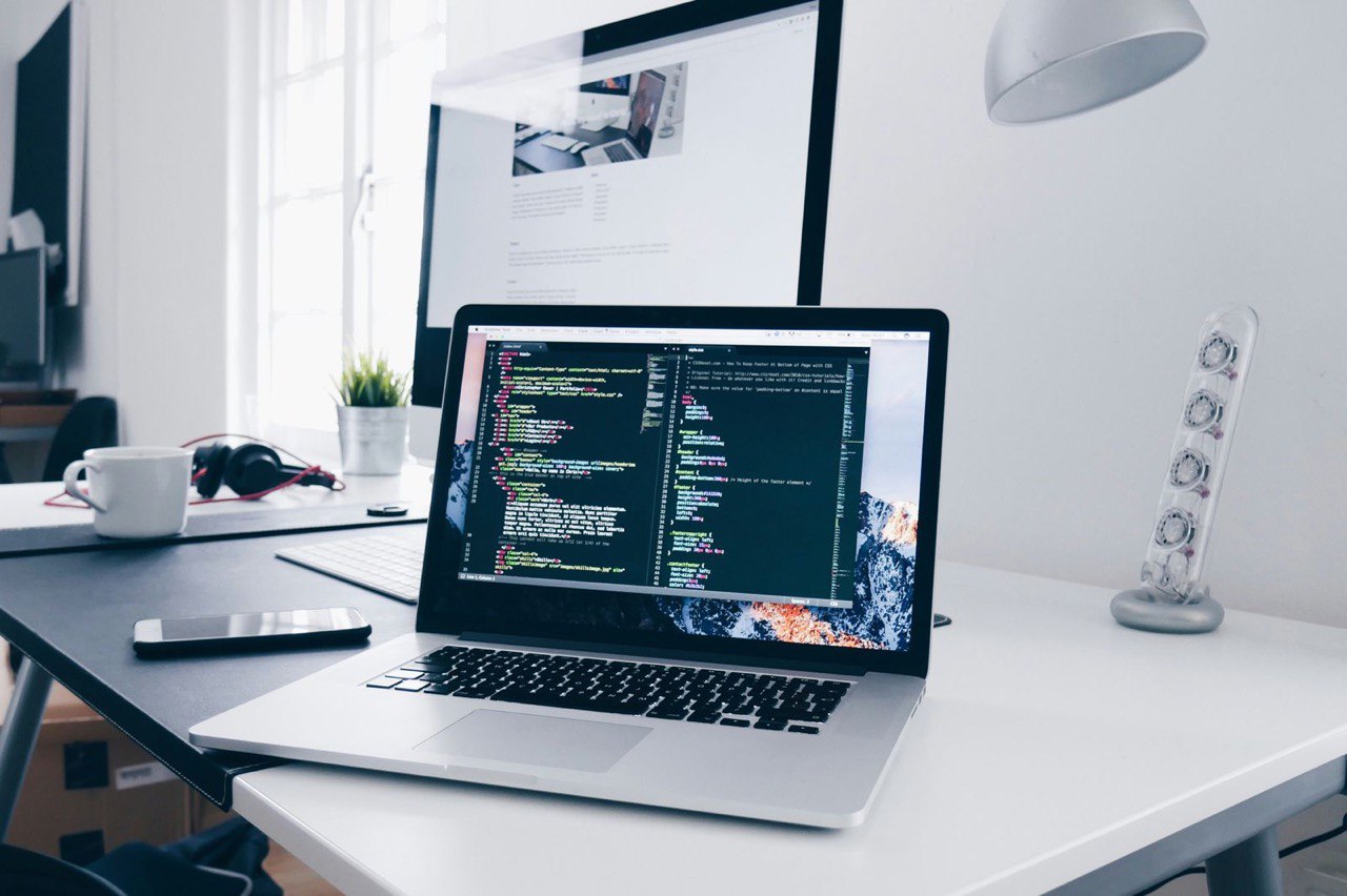 Technology Industry - Modern workspace with laptop showing code